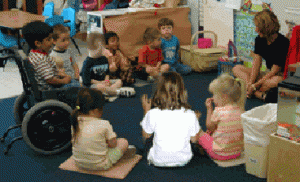 A group of children sit at circle time