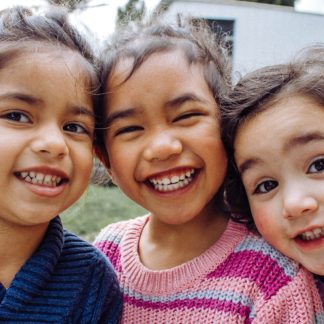 three young girls laughing