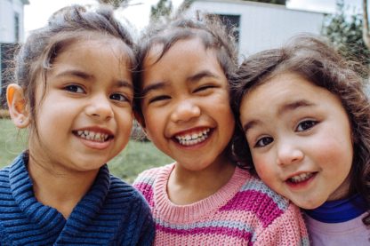 three young girls laughing