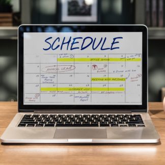 Macbook Pro Turned-on Displaying Schedule on Table