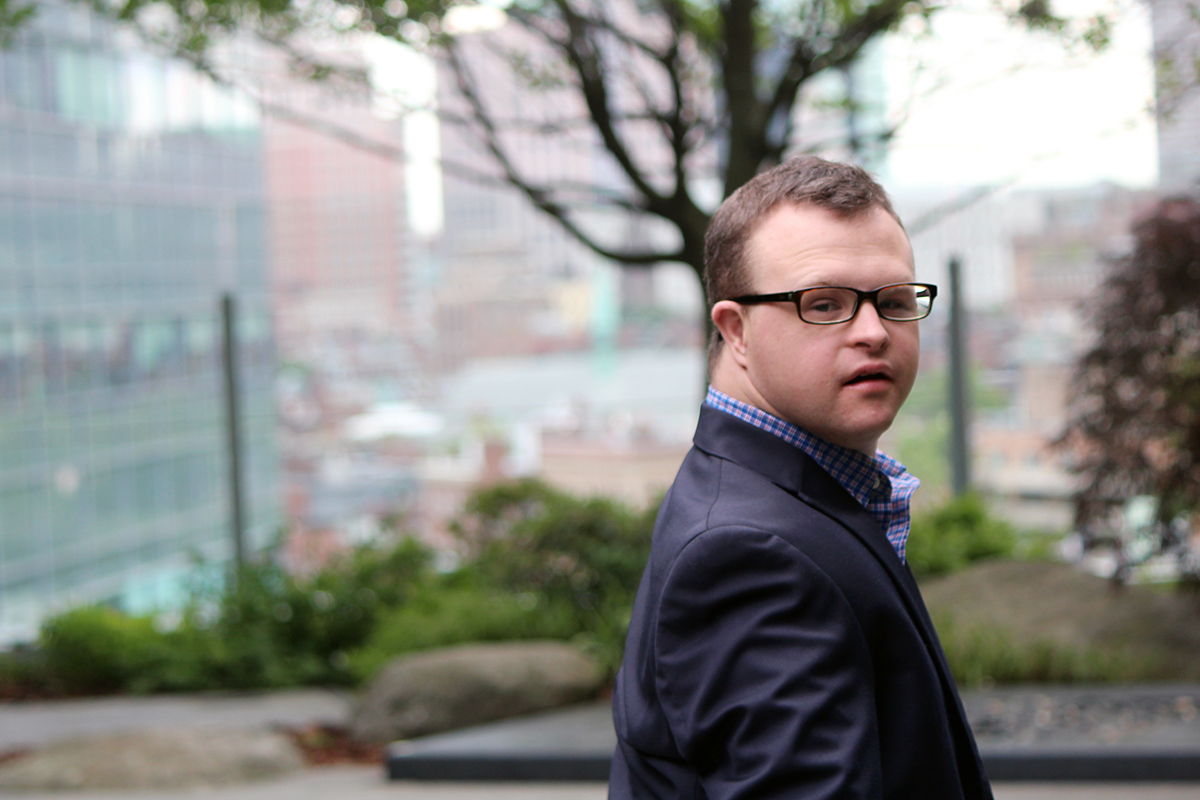 Young man with Down syndrome looking at the camera.