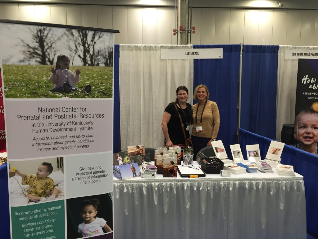 Two women at an exhibit booth.