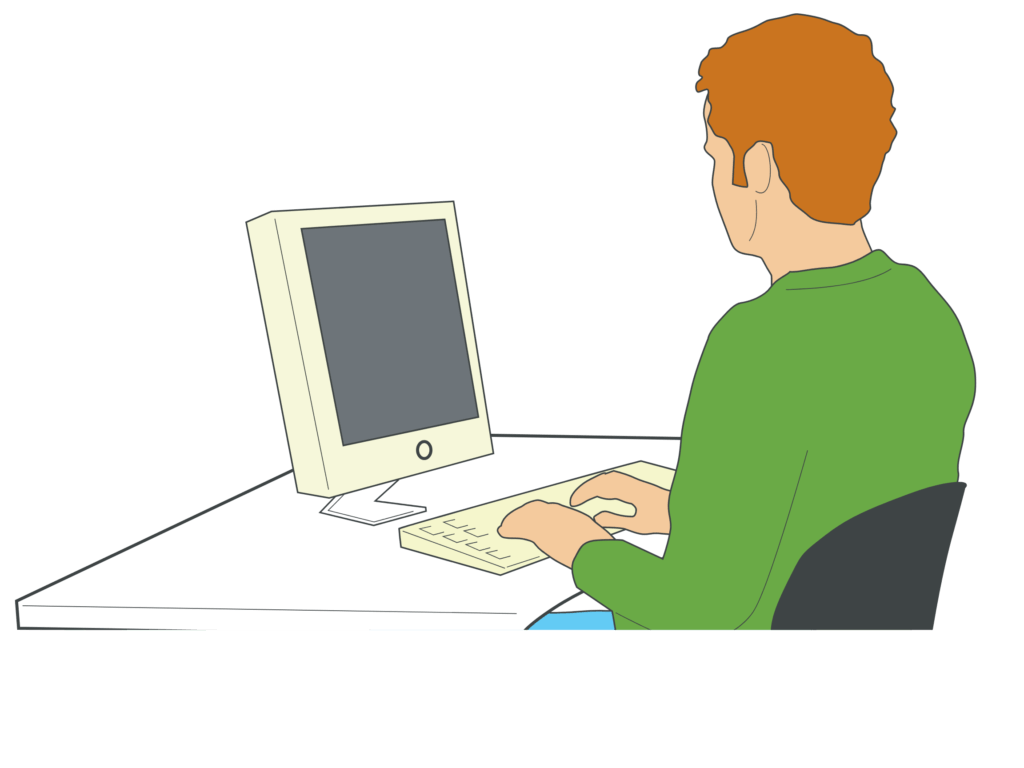 Red headed man with a green shirt sitting and typing on a computer