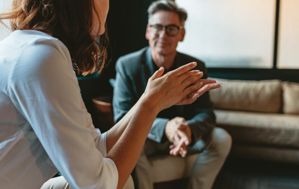 Two  people discussing in office lounge. 