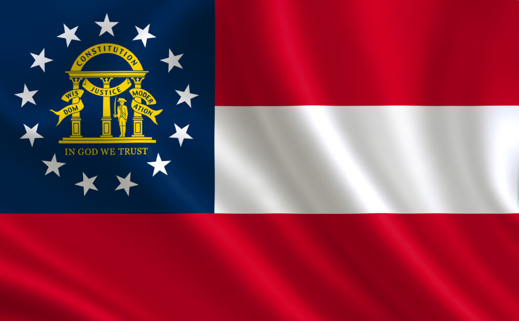 Georgia state flag image, blue square on upper left with the Georgia seal, white bar on upper right. Red bar below.