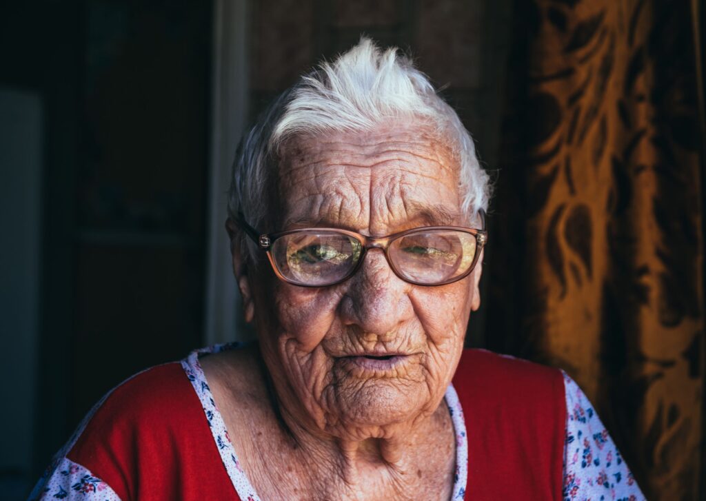 Older woman with short gray hair and brown glasses.