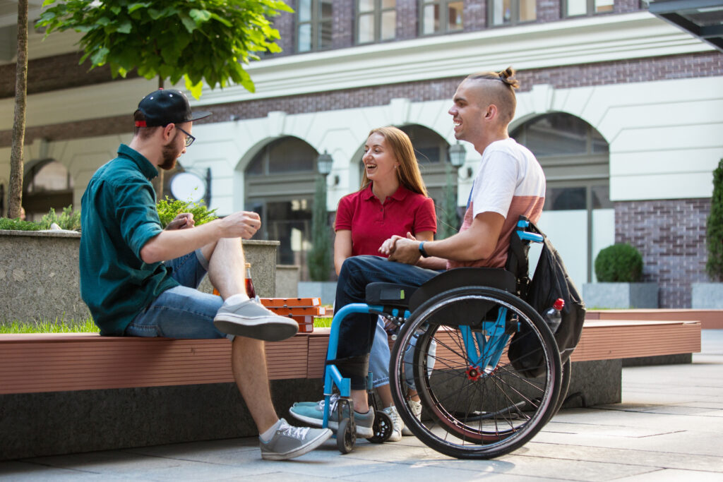 a person with a disability engaging in the community and meeting with friends.