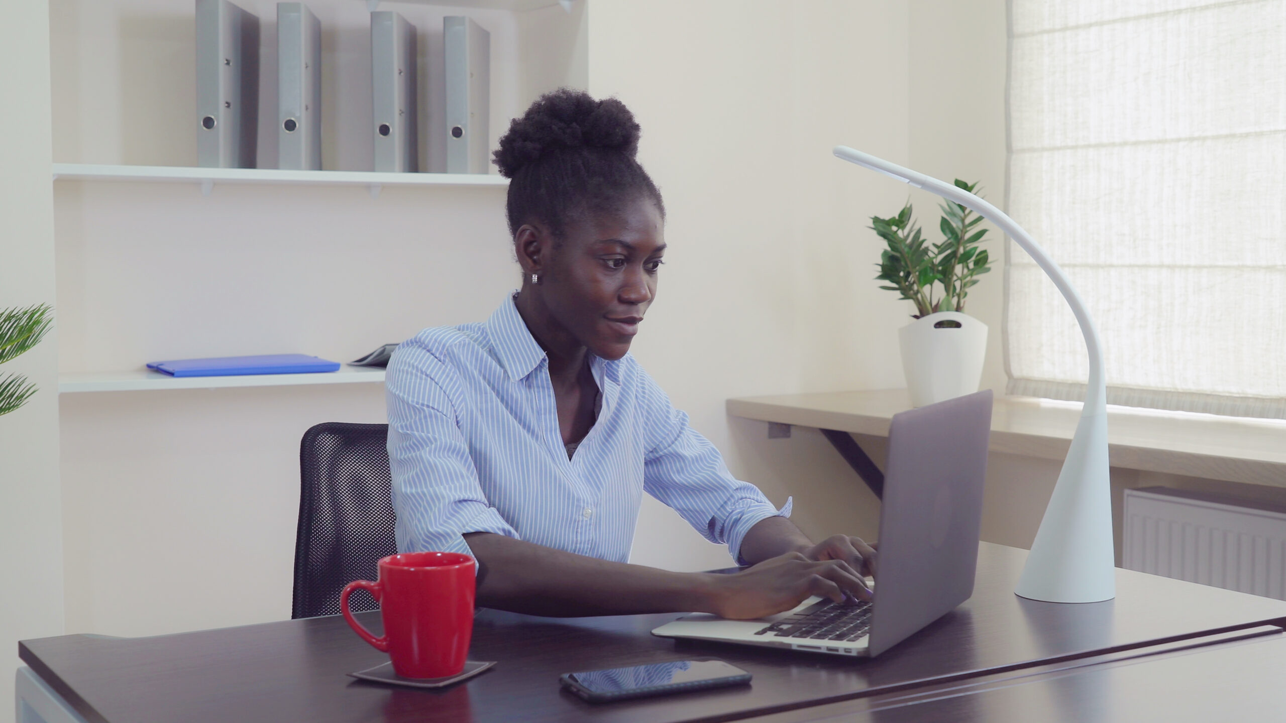 African female use pc at work.