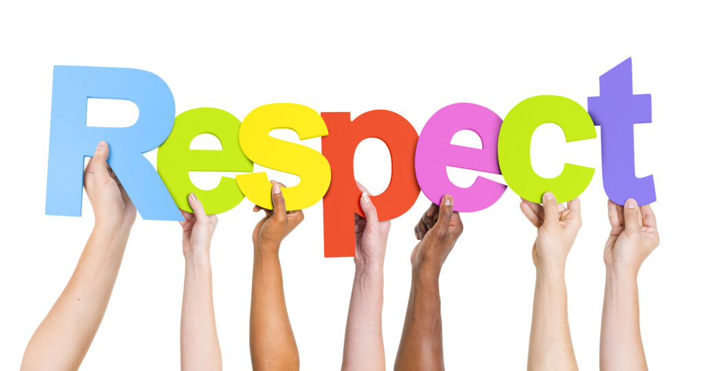 Hands holding up letters to spell "respect".