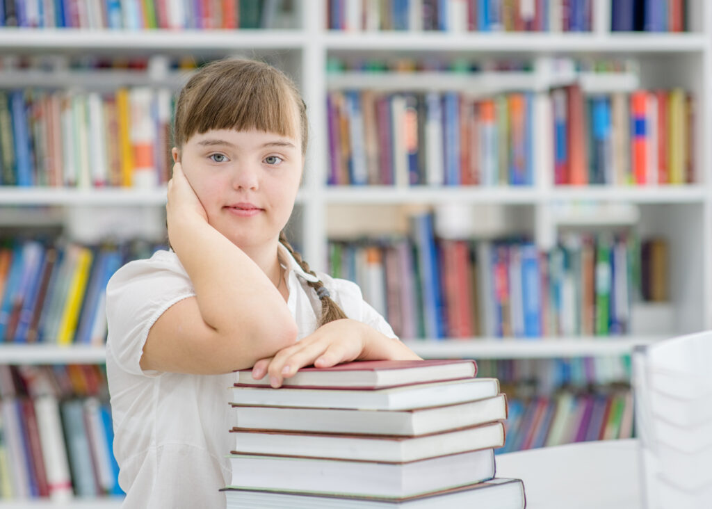 Portrait of a young girl with special needs at library.